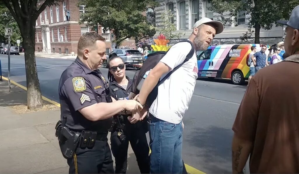Shocking Turn of Events: Man Arrested for Quoting Bible at Pride Rally – Crowd Goes Wild as He's Handcuffed!